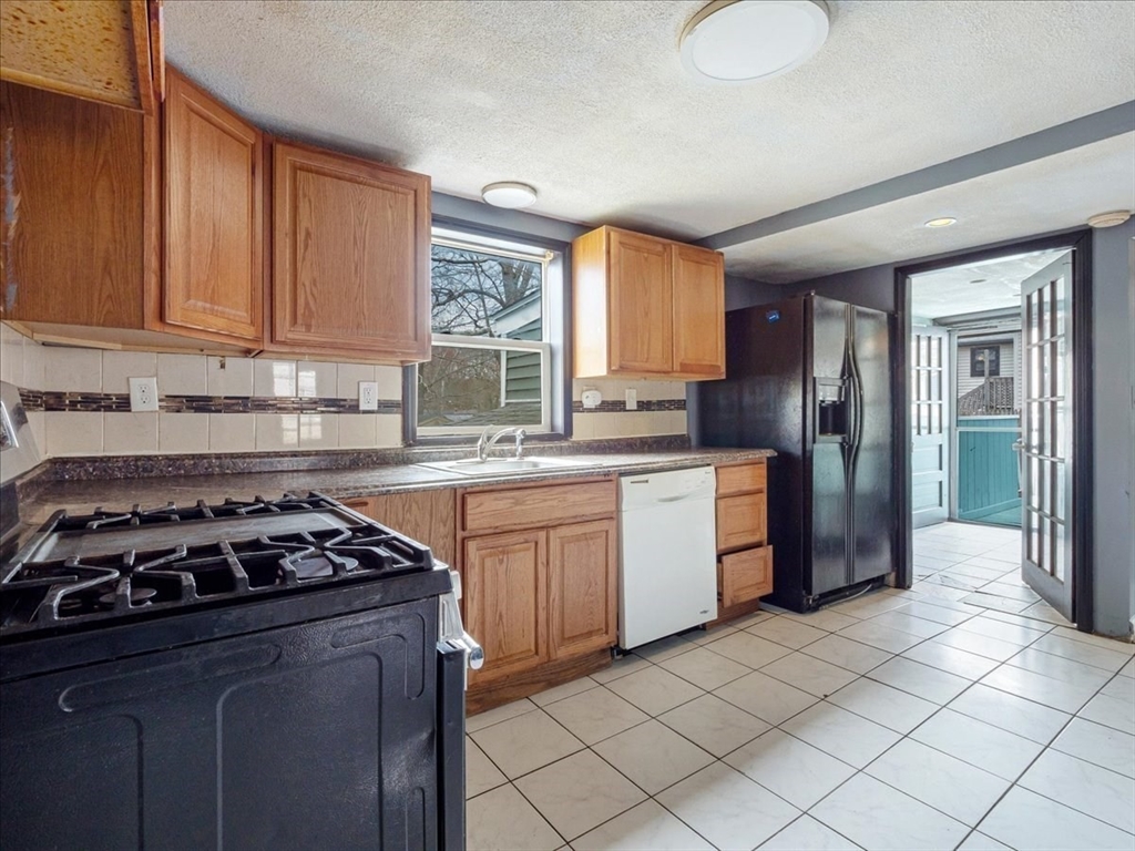 10 East Shore Road Holbrook, MA 02343 - Photo 15 of 30 a kitchen with a stove a sink and a refrigerator