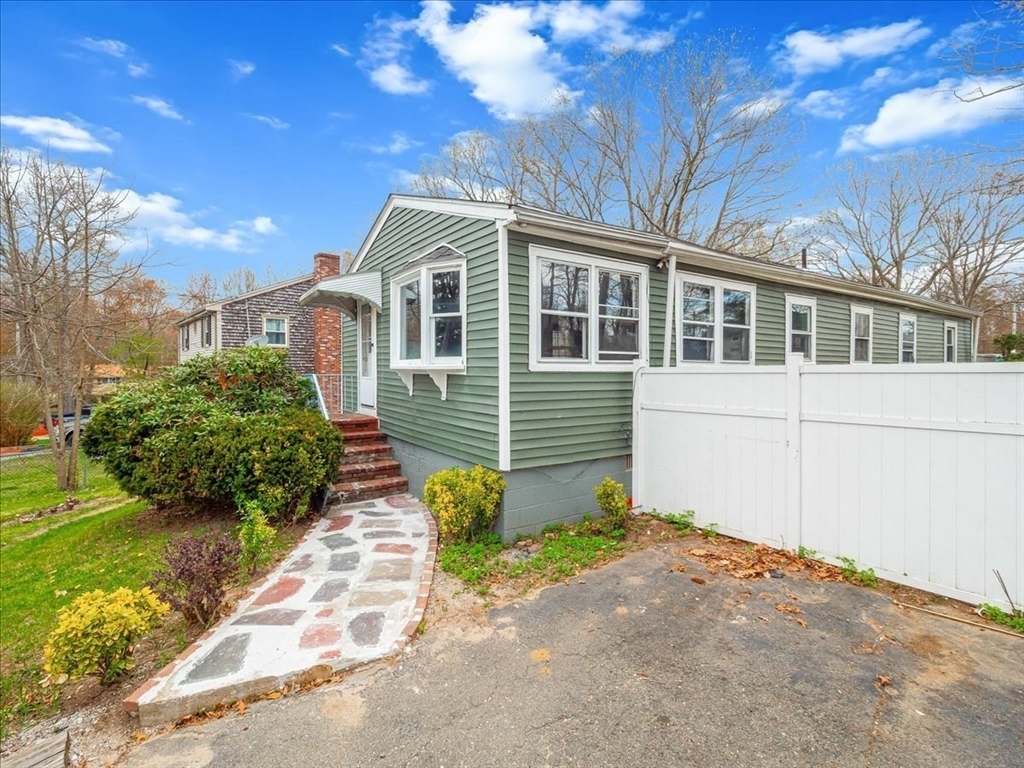 10 East Shore Road Holbrook, MA 02343 - Photo 2 of 30 a front view of a house with a garden