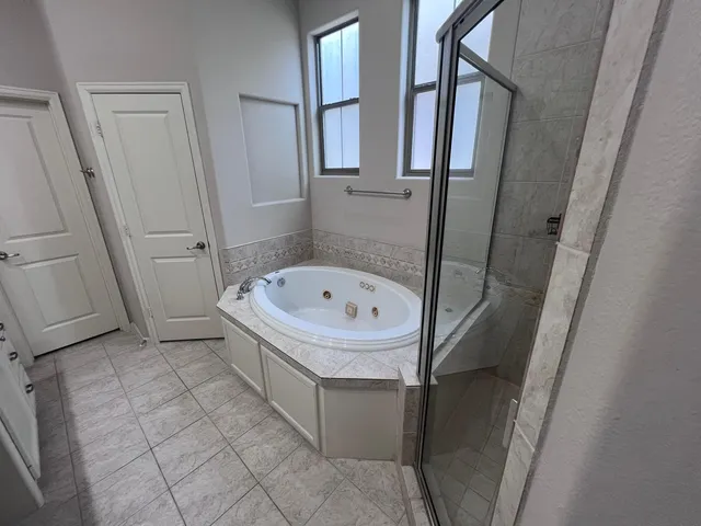 a bathroom with a bathtub and a shower