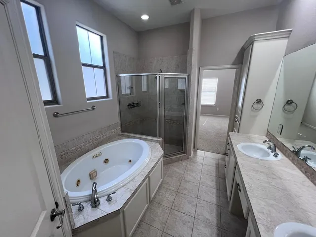 a bathroom with a tub sink and mirror