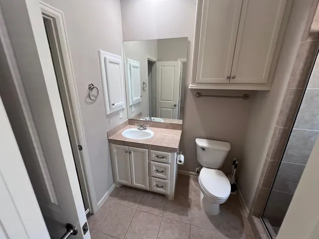a bathroom with a toilet a sink and a mirror