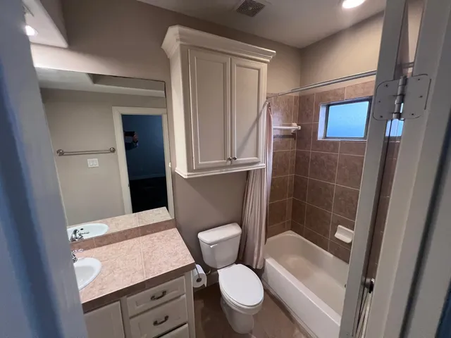 a bathroom with a toilet a sink and shower