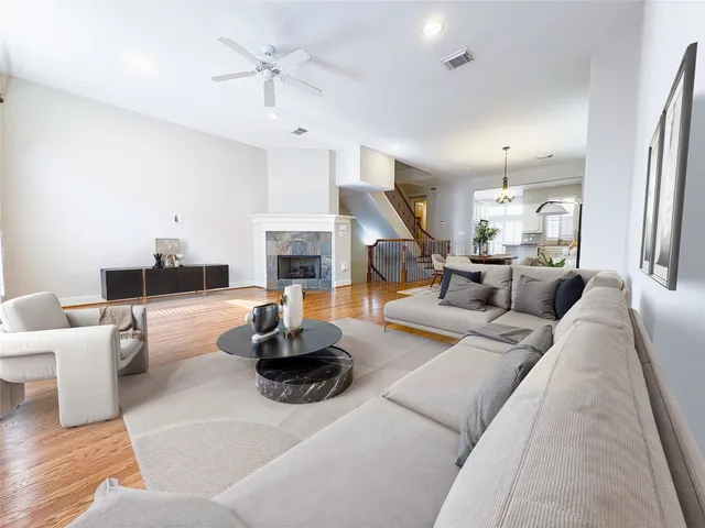 a living room with furniture fireplace and a large window