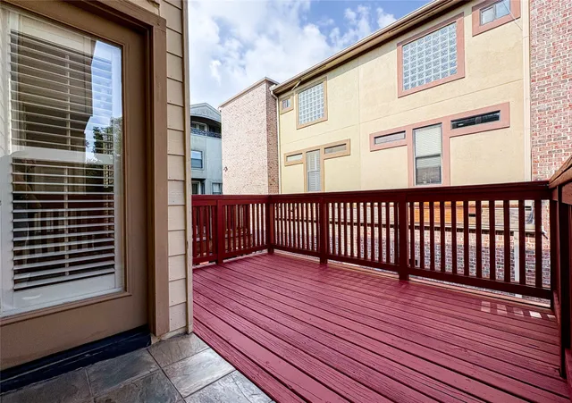 a view of a balcony with wooden floor