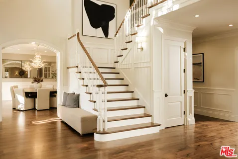 a view of entryway and kitchen with wooden floor