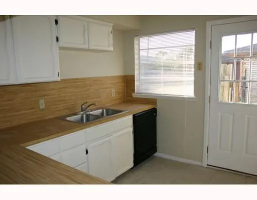 a kitchen with a sink cabinets and window