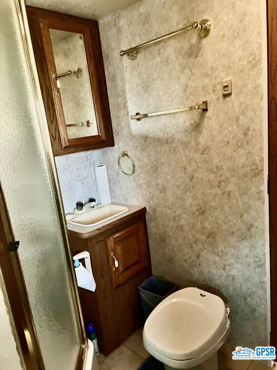 70201 Aurora Road Desert Hot Springs, CA 92241 - Photo 13 of 18 a bathroom with a toilet and a shower