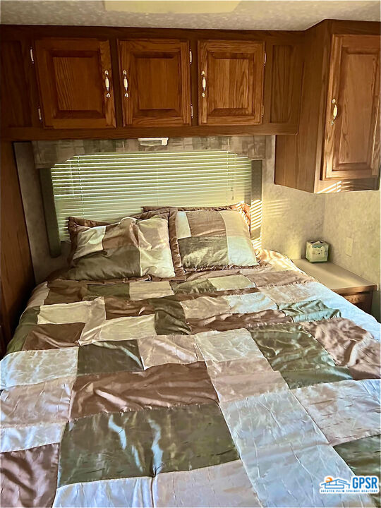 70201 Aurora Road Desert Hot Springs, CA 92241 - Photo 15 of 18 a bed sitting in a kitchen next to a cabinet