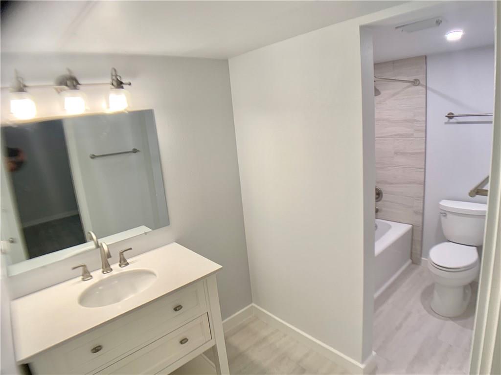 1135 Barton Hills Drive, Unit 252 Austin, TX 78704 - Photo 11 of 19 Bathroom featuring vanity, shower / bathtub combination, and light wood finished floors