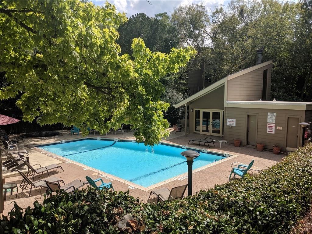 1135 Barton Hills Drive, Unit 252 Austin, TX 78704 - Photo 17 of 19 Community pool featuring a patio and view of wooded area