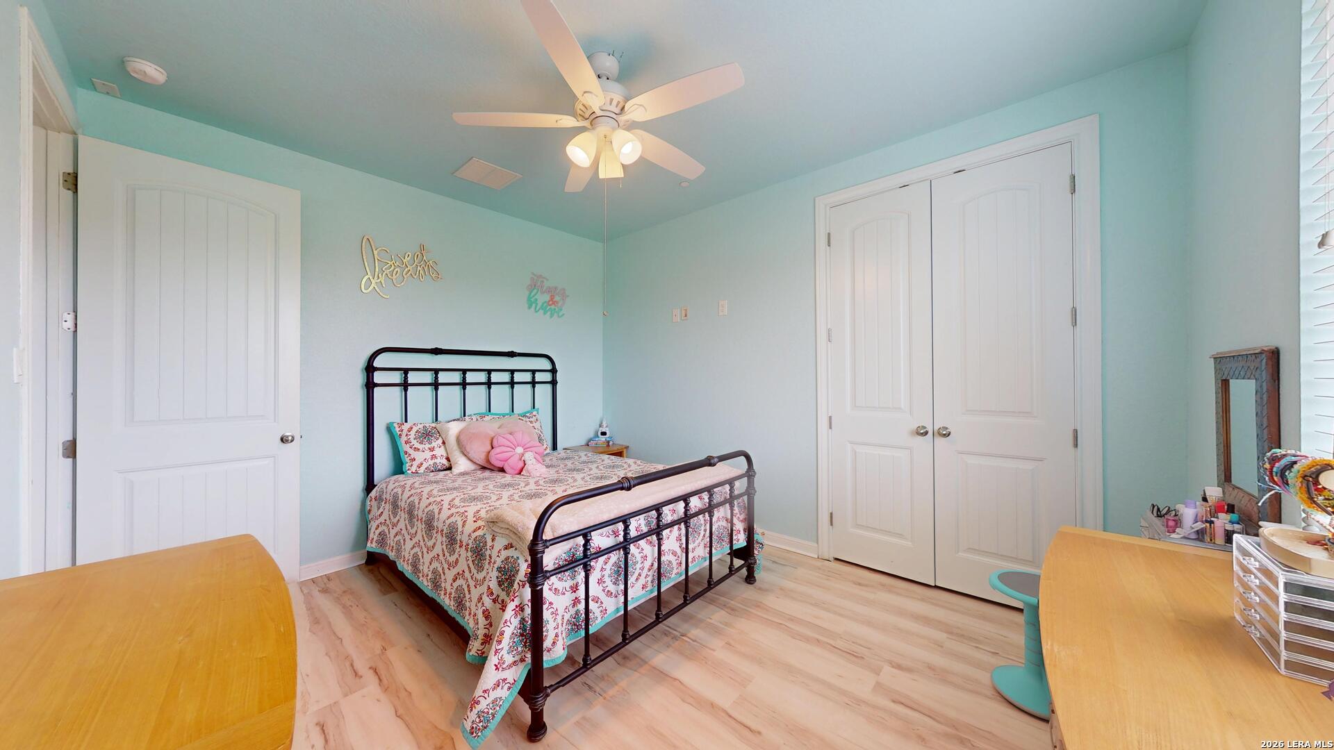 10111 Shallow Bank Converse, TX 78109 - Photo 31 of 65 a bedroom with a bed and a chandelier