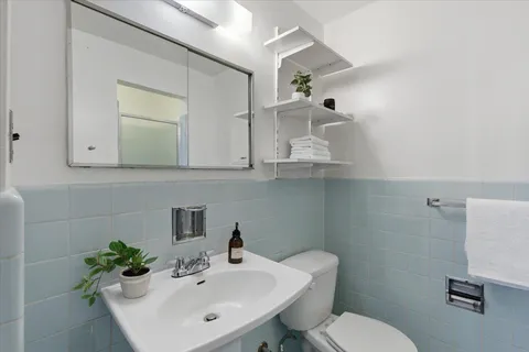 a utility room with dryer washer and a view of kitchen