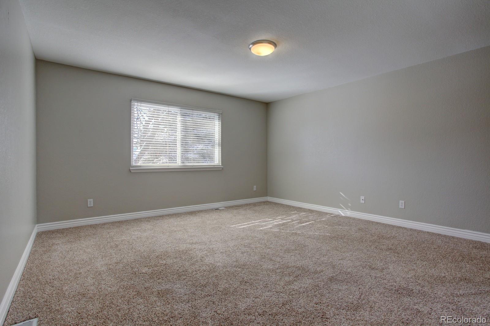 63 Prairie Ridge Road Highlands Ranch, CO 80126 - Photo 12 of 29 an empty room with windows