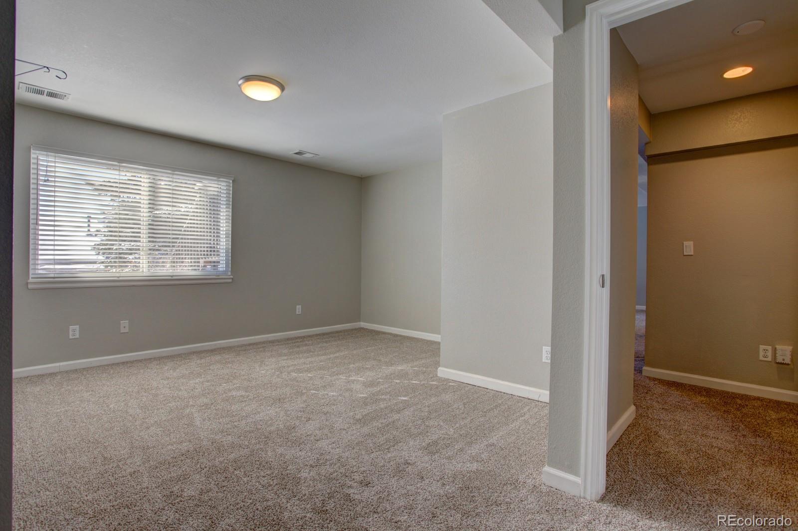 63 Prairie Ridge Road Highlands Ranch, CO 80126 - Photo 19 of 29 an empty room with windows