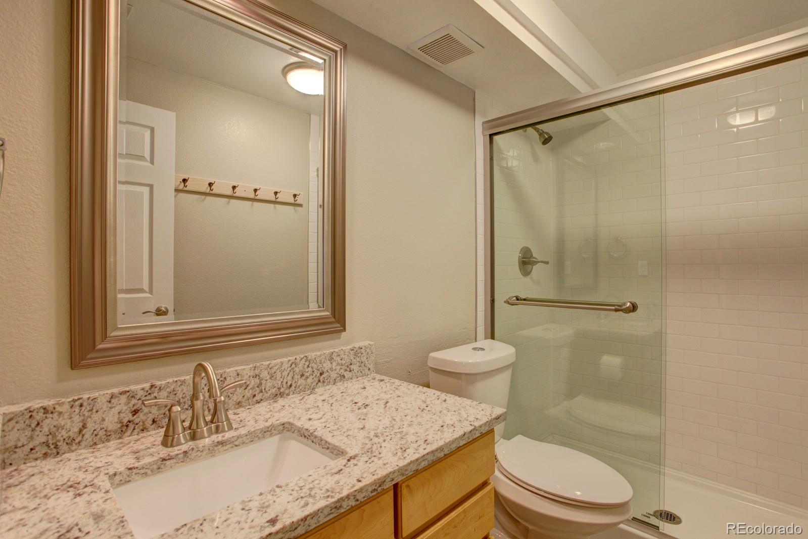 63 Prairie Ridge Road Highlands Ranch, CO 80126 - Photo 20 of 29 a bathroom with a granite countertop sink toilet and shower