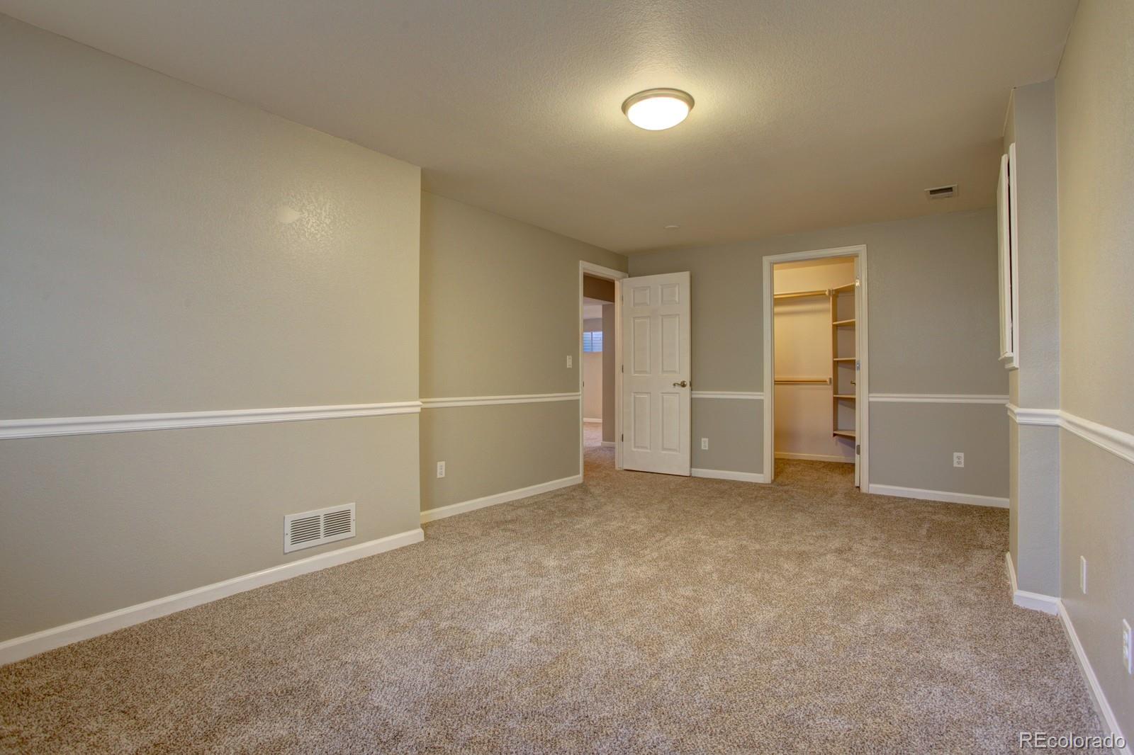 63 Prairie Ridge Road Highlands Ranch, CO 80126 - Photo 23 of 29 an empty room with closet and windows