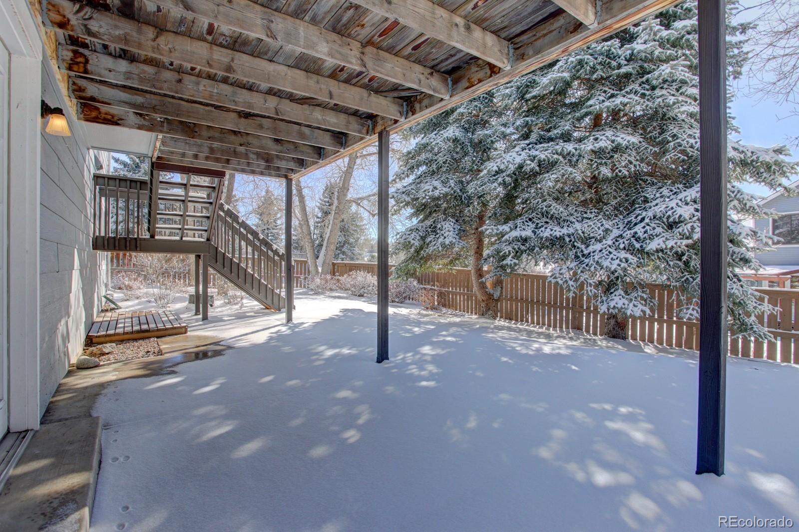 63 Prairie Ridge Road Highlands Ranch, CO 80126 - Photo 24 of 29 a view of a backyard with wooden fence