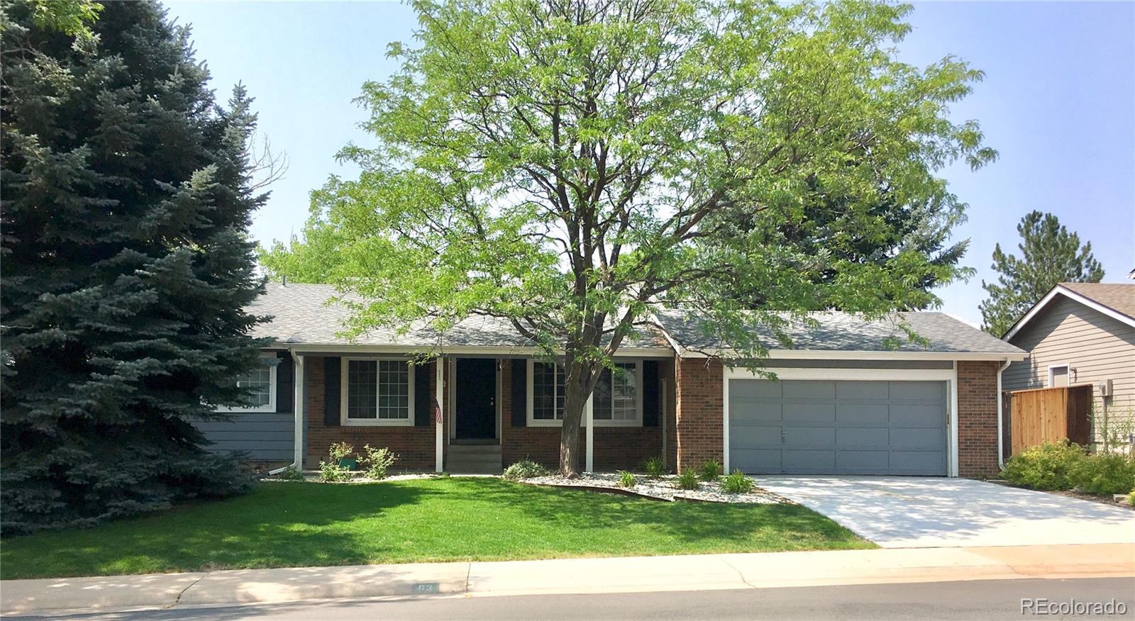63 Prairie Ridge Road Highlands Ranch, CO 80126 - Photo 29 of 29 a front view of a house with a yard and a garden