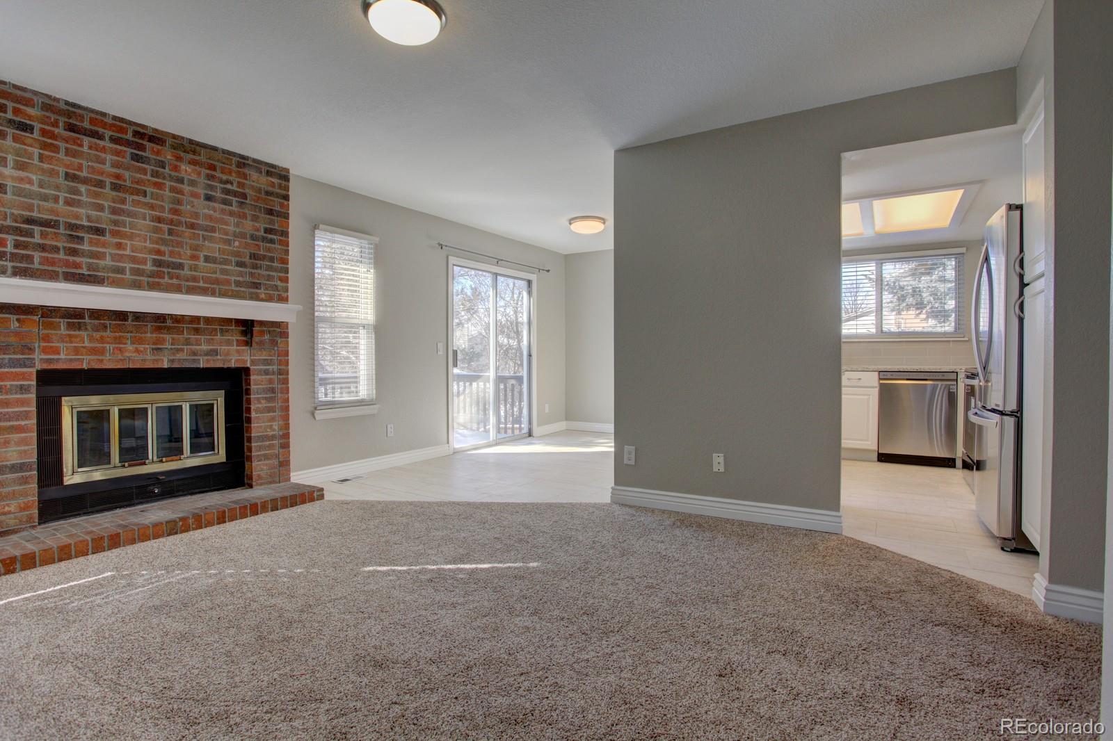 63 Prairie Ridge Road Highlands Ranch, CO 80126 - Photo 4 of 29 an empty room with windows and fireplace