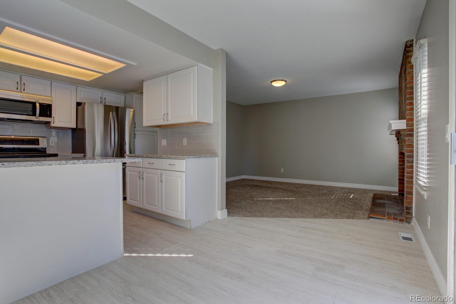 63 Prairie Ridge Road Highlands Ranch, CO 80126 - Photo 5 of 29 a kitchen with stainless steel appliances a refrigerator sink and microwave