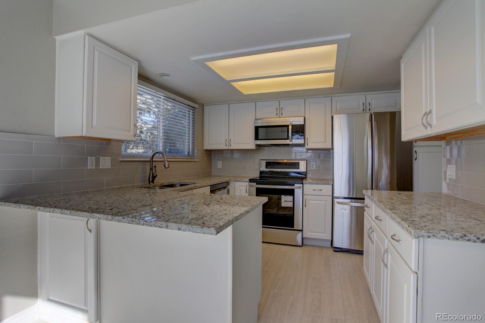 63 Prairie Ridge Road Highlands Ranch, CO 80126 - Photo 6 of 29 a kitchen with a sink stove and refrigerator