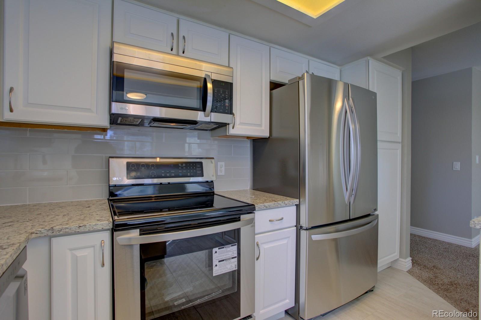63 Prairie Ridge Road Highlands Ranch, CO 80126 - Photo 8 of 29 a kitchen with a refrigerator stove and microwave