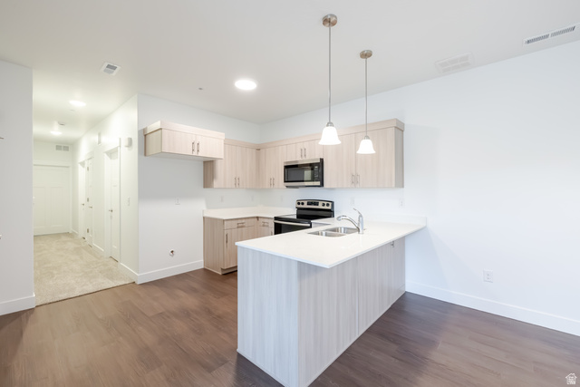 4695 South 690th West, Unit U101 Mapleton, UT 84664 - Photo 12 of 16 Open-concept kitchen with light wood-finish cabinetry, white countertops, and stainless steel appliances