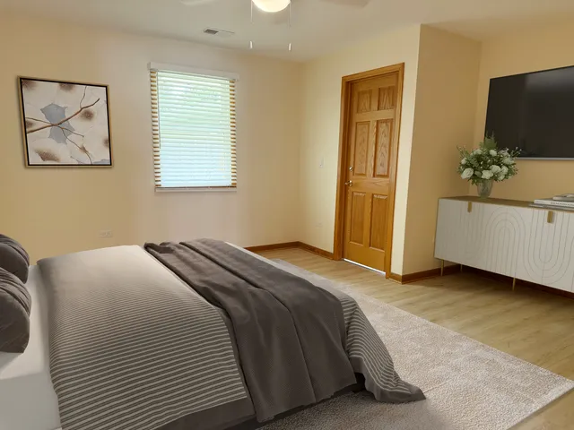 a bedroom with a bed and a flat screen tv