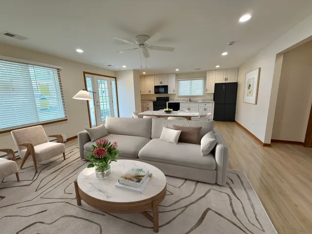 a living room with furniture and a wooden floor