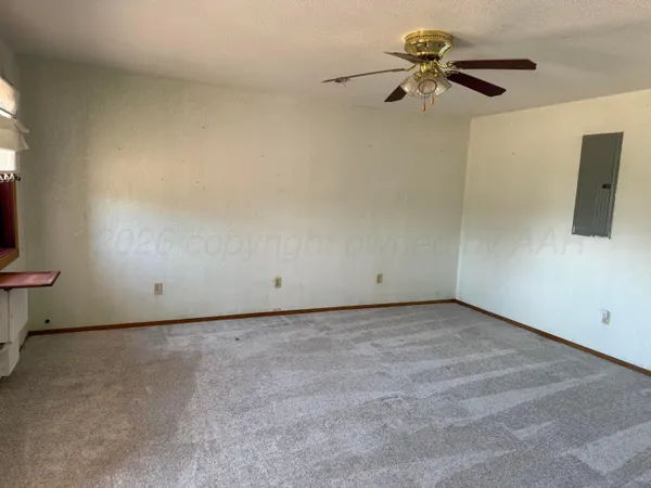 a view of a room with a ceiling fan and a window