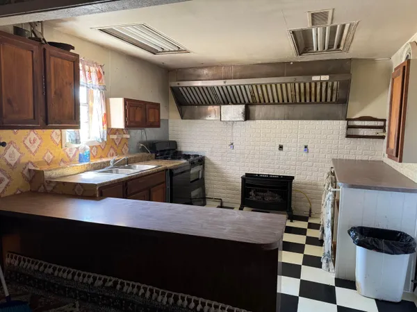 a kitchen with a sink a stove and a refrigerator