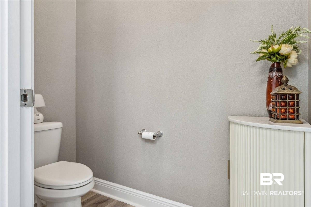 7022 Rocky Rd Loop Gulf Shores, AL 36542 - Photo 50 of 59 Bathroom with toilet and wood finished floors