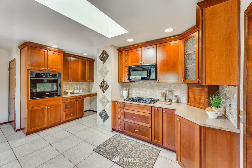 822 Rucker Avenue Everett, WA 98201 - Photo 11 of 40 a large kitchen with stainless steel appliances granite countertop a sink and cabinets