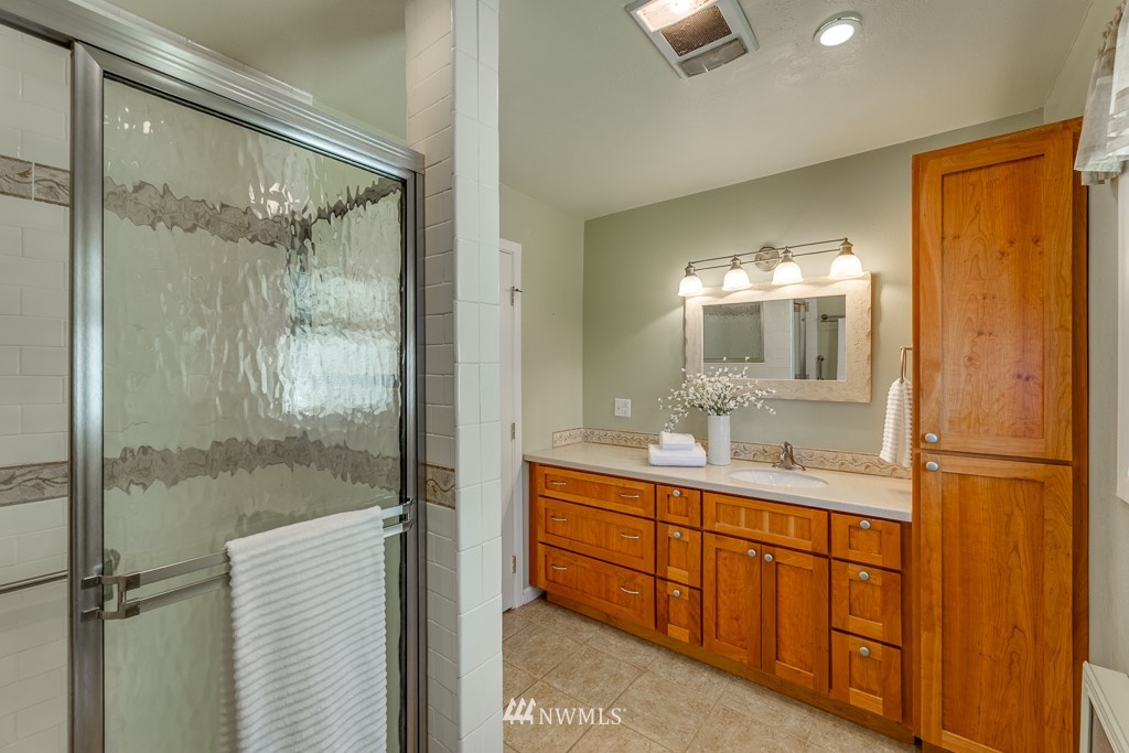 822 Rucker Avenue Everett, WA 98201 - Photo 16 of 40 a bathroom with a double vanity sink and mirror with shower