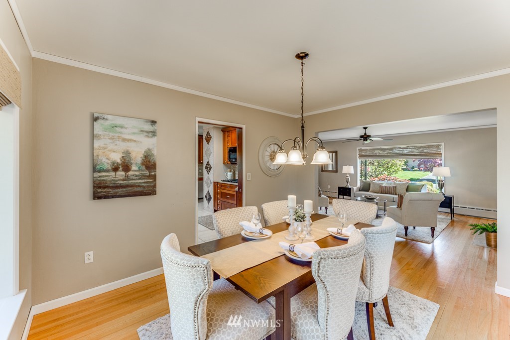 822 Rucker Avenue Everett, WA 98201 - Photo 9 of 40 a dining room with wooden floor a chandelier a wooden table and chairs