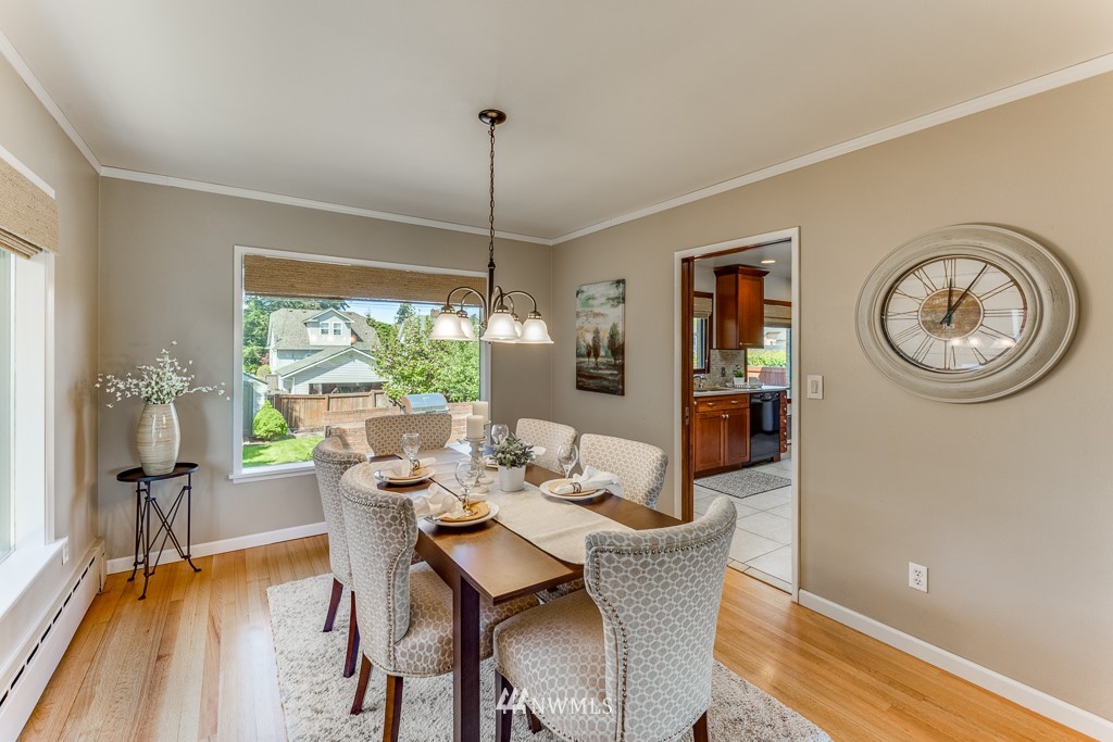 822 Rucker Avenue Everett, WA 98201 - Photo 10 of 40 a dining room with furniture a chandelier and wooden floor