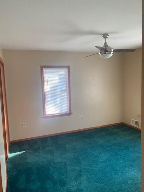2407 Eastbrook Road New Castle, PA 16105 - Photo 6 of 17 an empty room with a window and a ceiling fan