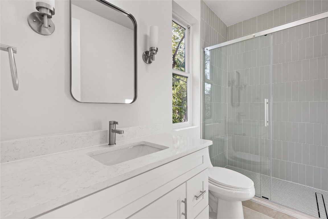 613 Clifford Drive, Unit A & B Austin, TX 78745 - Photo 24 of 40 a bathroom with a sink a toilet and a mirror