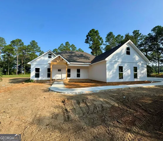 a view of a white house with a yard