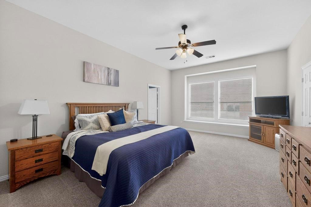 236 Hope Circle Murphy, TX 75094 - Photo 17 of 38 Primary Bedroom with ceiling fan and window seat
