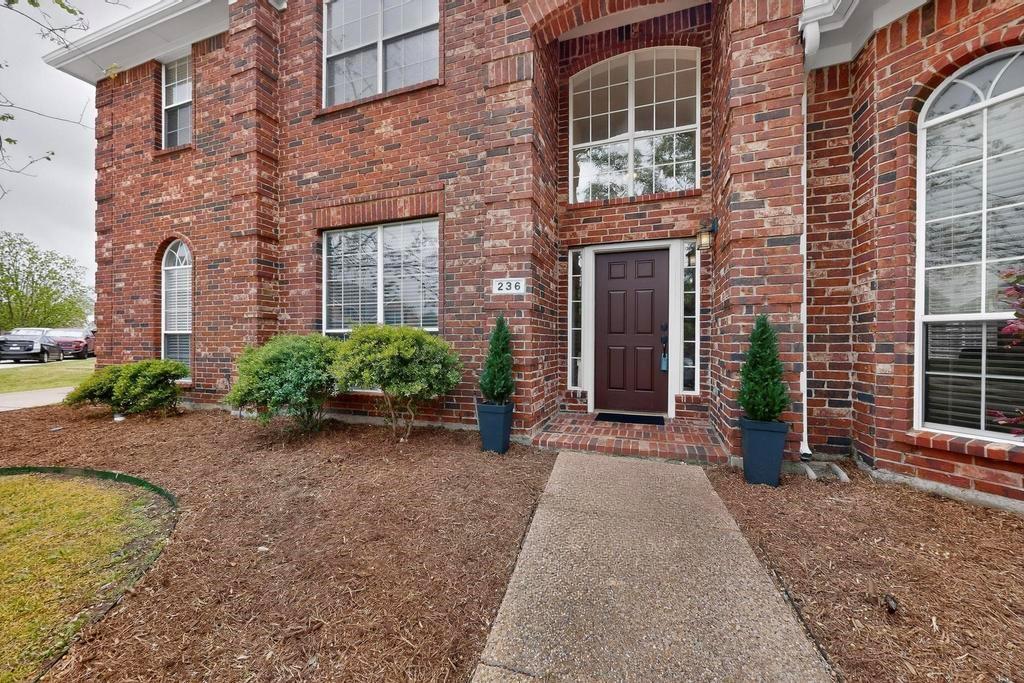 236 Hope Circle Murphy, TX 75094 - Photo 2 of 38 Inviting entry to property featuring freshly mulched flower beds