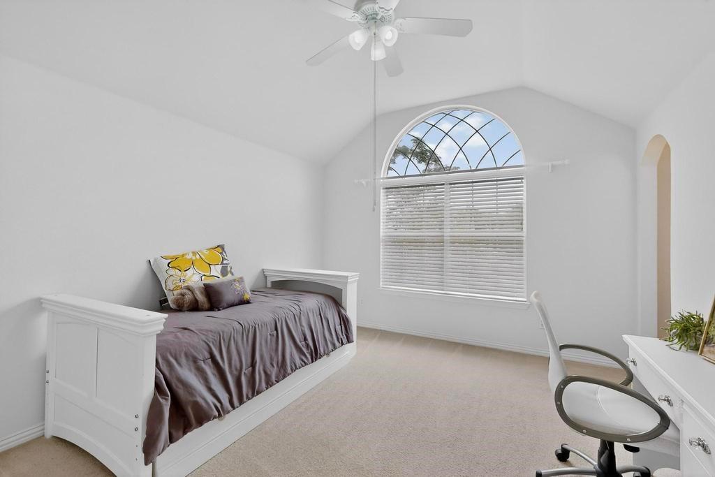 236 Hope Circle Murphy, TX 75094 - Photo 28 of 38 Bedroom with lofted ceiling, a ceiling fan, arched walkways to the Jack and Jill bathroom and a large beautiful window