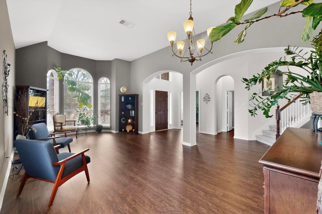 236 Hope Circle Murphy, TX 75094 - Photo 5 of 38 Entrance foyer with arched walkways, dark wood-like LVP flooring, and lofted ceiling