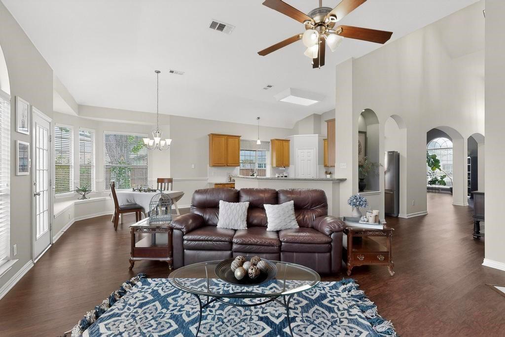 236 Hope Circle Murphy, TX 75094 - Photo 10 of 38 Living room with arched walkways and view of the kitchen