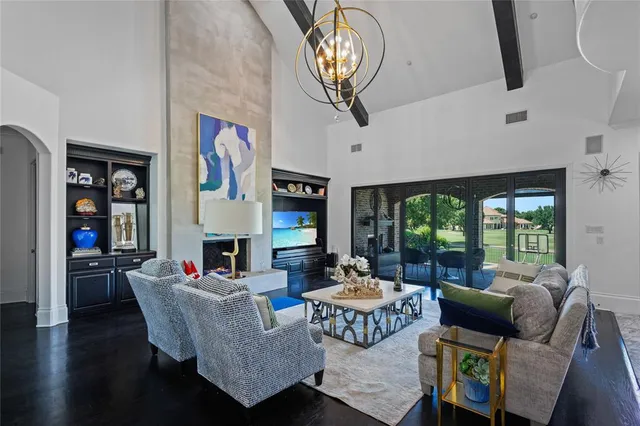 a living room with fireplace furniture and a large window