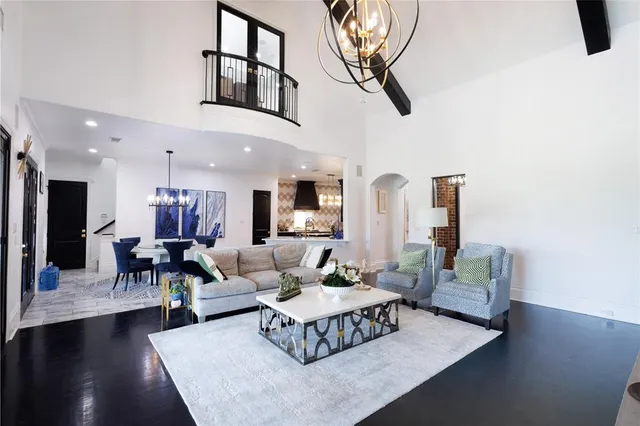 a living room with furniture wooden floor and a chandelier
