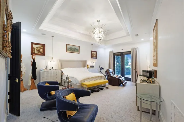 a bedroom with 2 bed and a chandelier