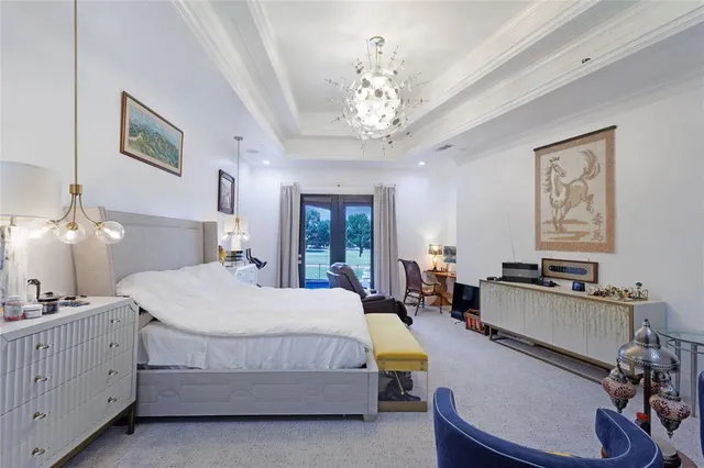 a bed room with a bed and a chandelier