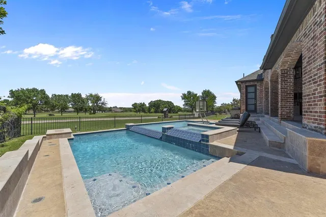 a view of a patio with swimming pool table and chairs