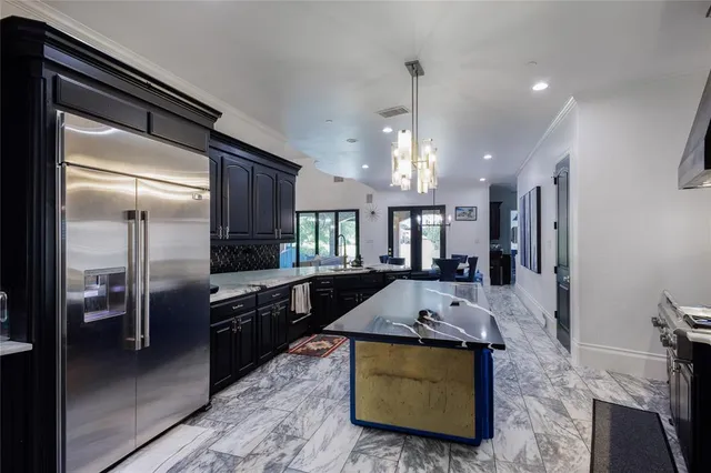 a large kitchen with stainless steel appliances lots of counter space